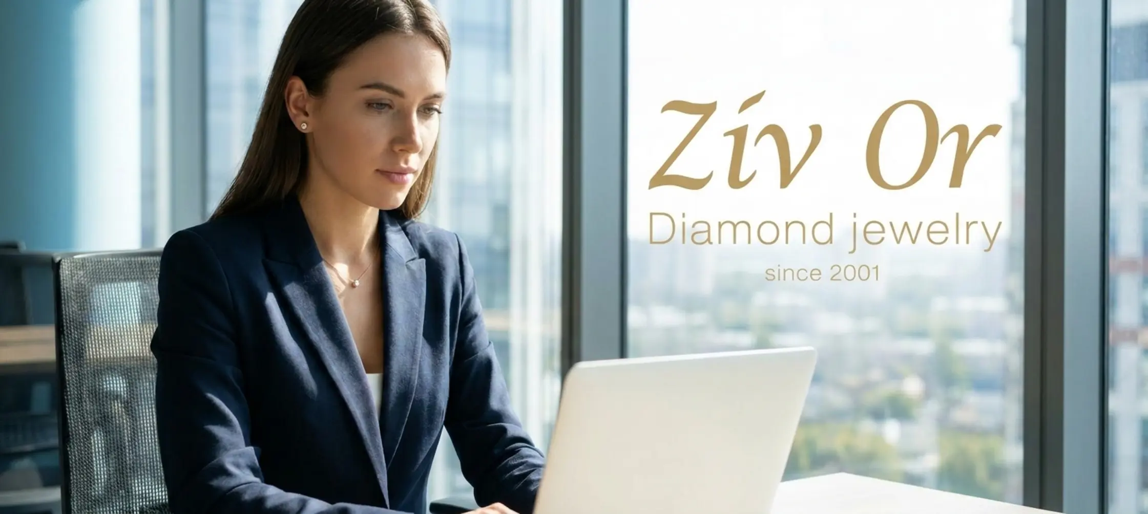 אישה צעירה ואלגנטית במשרד מודרני, לובשת חליפת עסקים מחויטת, עונדת עגילי יהלום צמודים ועדינים ושרשרת דקה עם תליון קטן, מקלידה על מחשב נייד